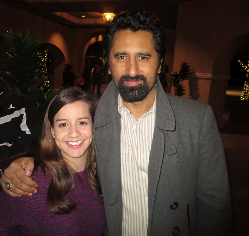 Cliff Curtis and smiling woman in cozy evening outdoor setting with glowing string lights and arches Wallpaper