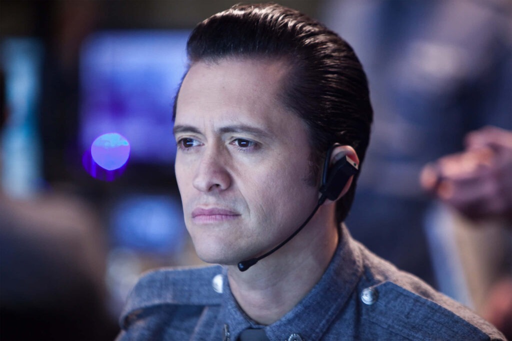 Clifton Collins Jr focused in formal uniform wearing headset dramatic cinematic lighting background Wallpaper