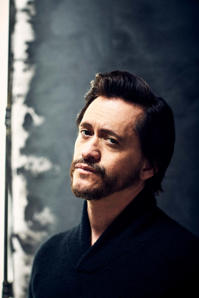 Clifton Collins Jr portrait with moody lighting dark textured backdrop contemplative expression Wallpaper