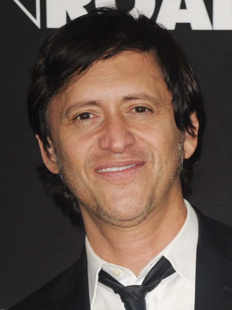 Clifton Collins Jr smiling in formal attire against dark background professional portrait wallpaper