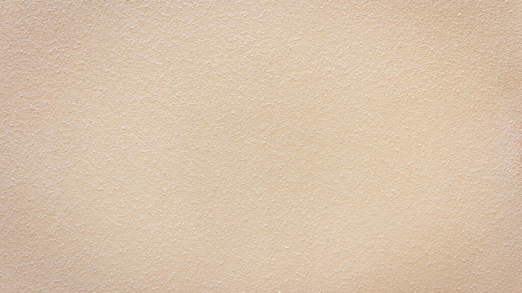 Textured Beige Wall Close-Up: Subtle Rough Surface Wallpaper Background