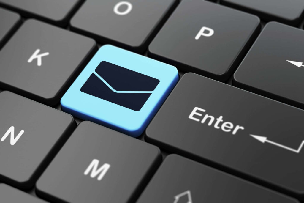 Close-up of black keyboard with blue email marketing key next to Enter key for digital strategy Wallpaper