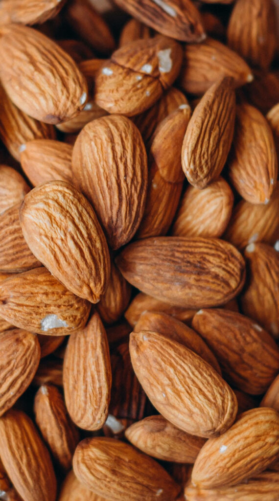 Wholesome Brown Almond Nuts: Natural Texture Wallpaper Background