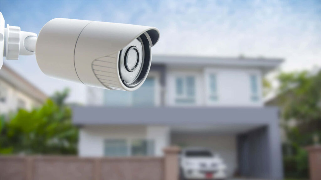 Close-Up of Robust C-Mount Security Camera Overlooking Modern Home Wallpaper