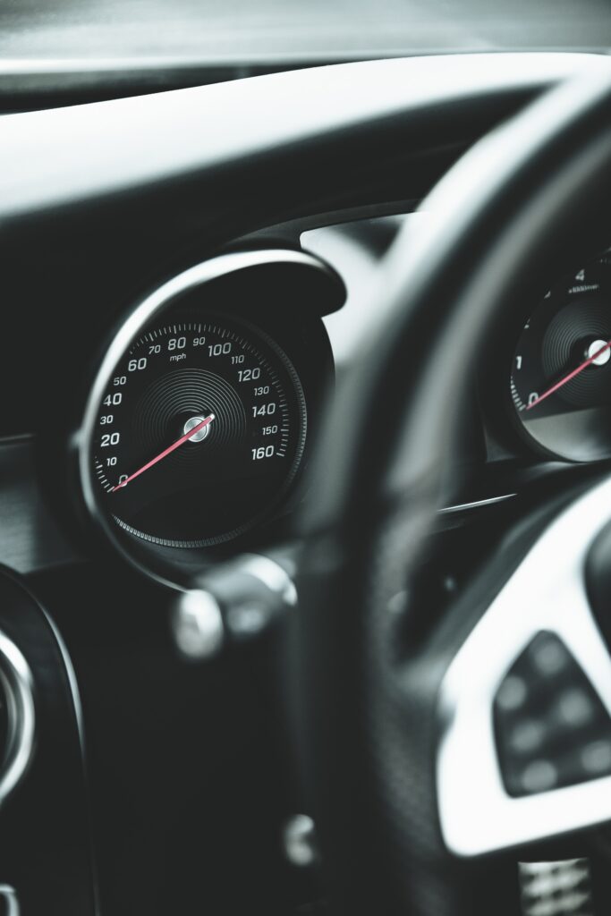 Close-Up Car Speedometer Wallpaper in Sleek Salon Interior