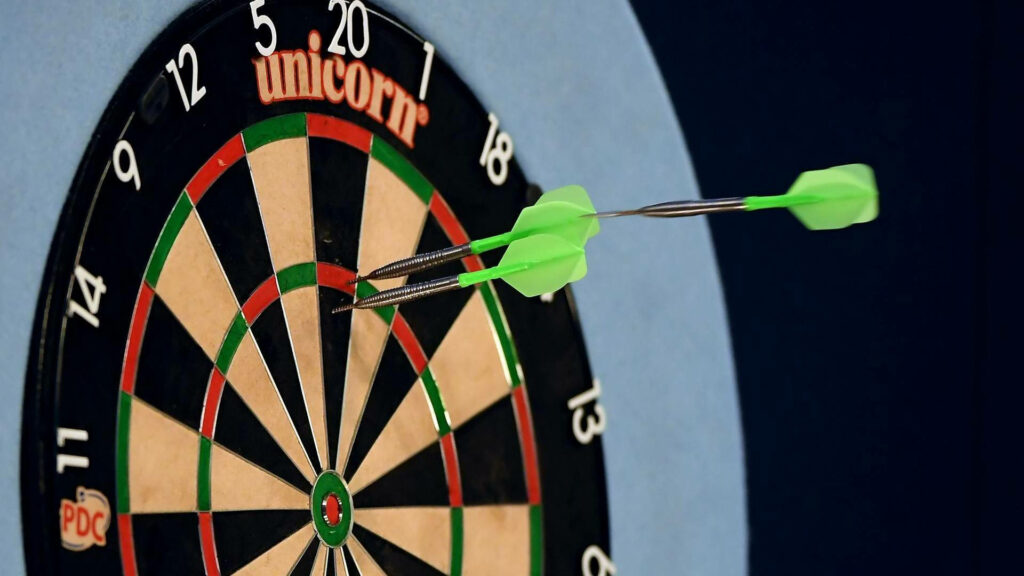 Close-Up Dartboard Wallpaper: Precision Darts & Competitive Spirit