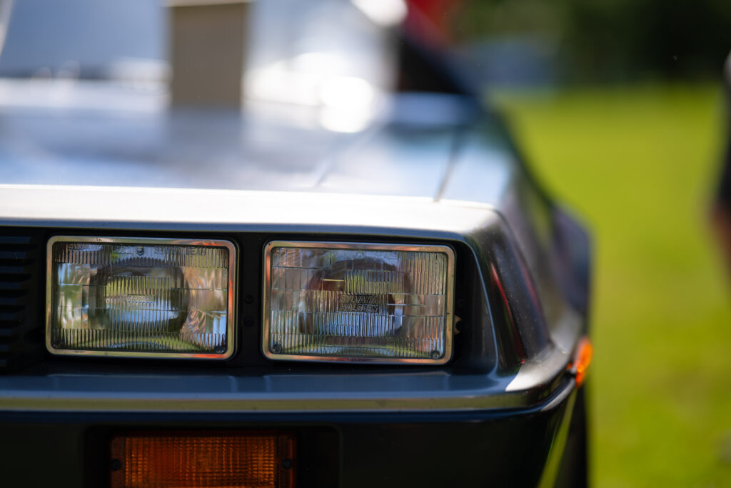 Close-Up of Iconic Delorean DMC-12 Headlights with Sleek Design Wallpaper
