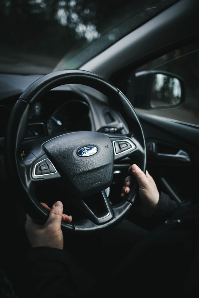 Close-Up of Hands on Ford Steering Wheel: Comfort & Control Wallpaper
