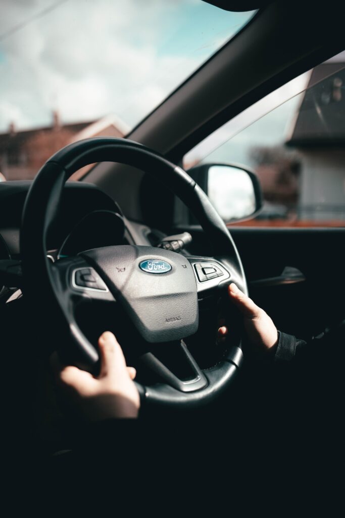 Close-Up of Ford Steering Wheel: Experience Driving Connection Wallpaper