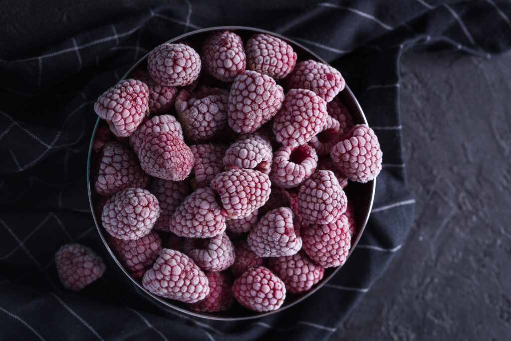 Close-Up of Frosty Raspberries in Bowl - Dark Textured Wallpaper