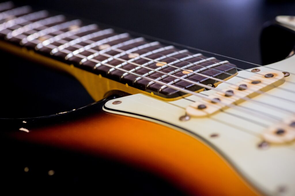 Intricate Guitar Neck Close-Up: Elegant Craftsmanship Wallpaper