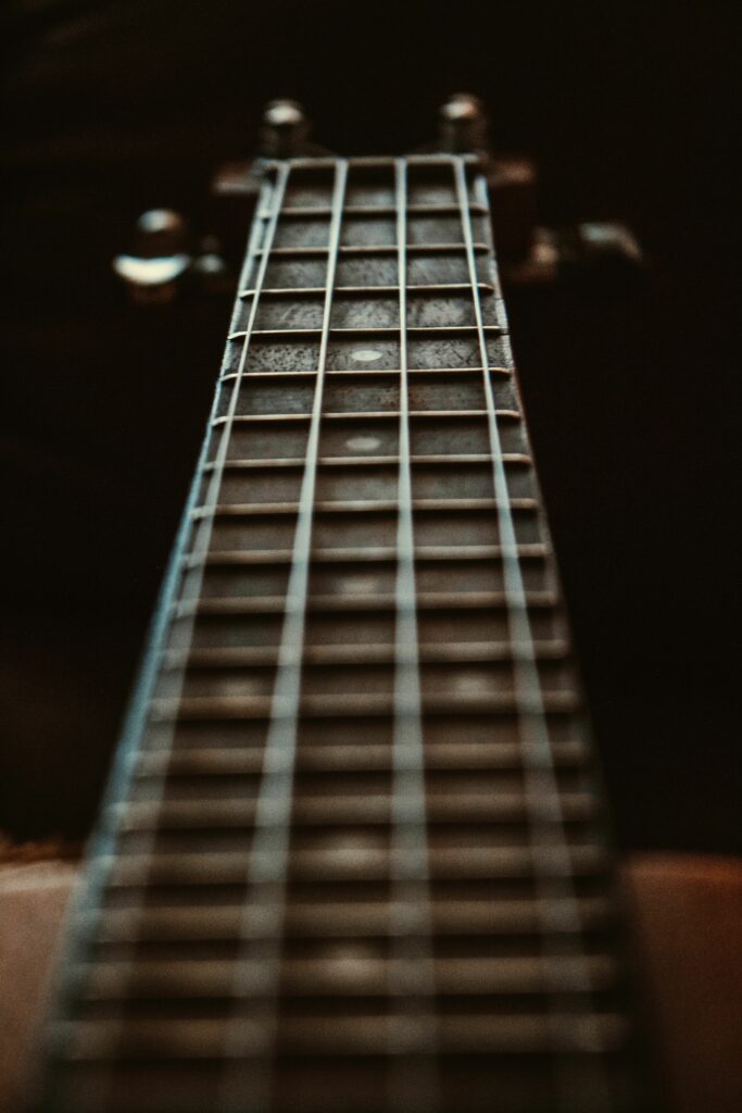 Close-Up Guitar Neck Wallpaper: Strings & Frets with Depth Effect