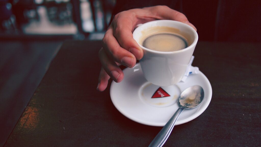 Close-Up of Espresso Cup on Saucer - Dark Table Background Wallpaper