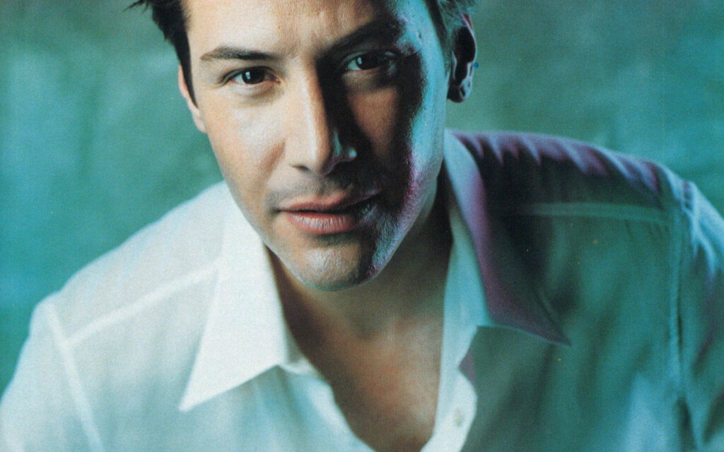 Keanu Reeves Close-Up Wallpaper: Charismatic in White Shirt Background