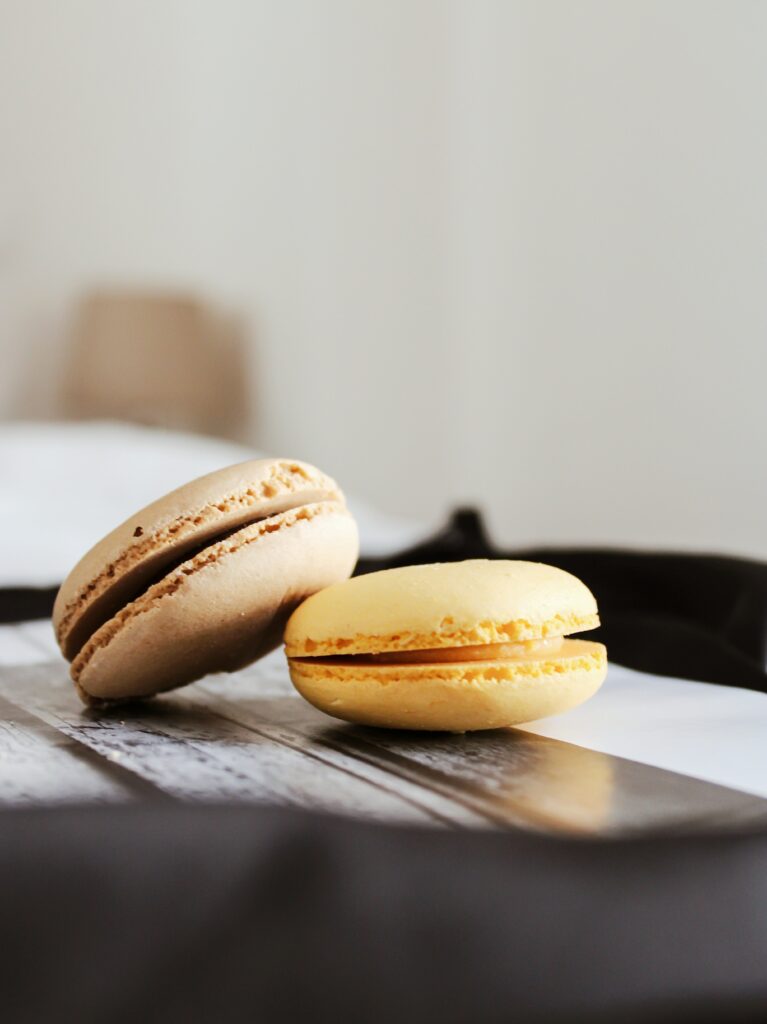 Close-Up of Beige & Yellow Macarons: Delicate Texture Wallpaper
