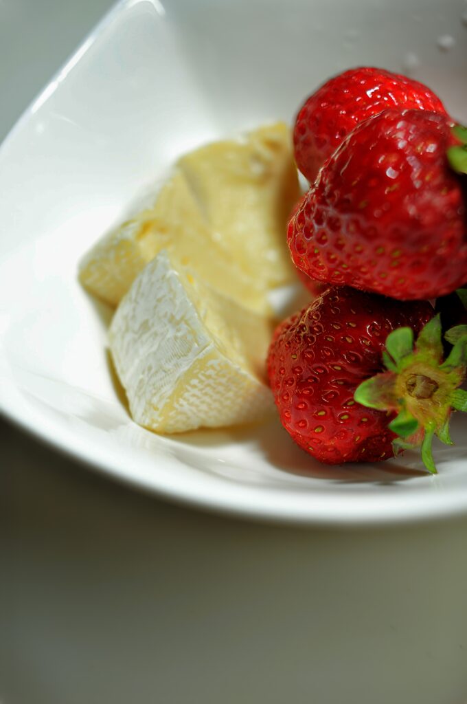 Macro Shot of Fresh Strawberries & Cheese on White Plate Wallpaper