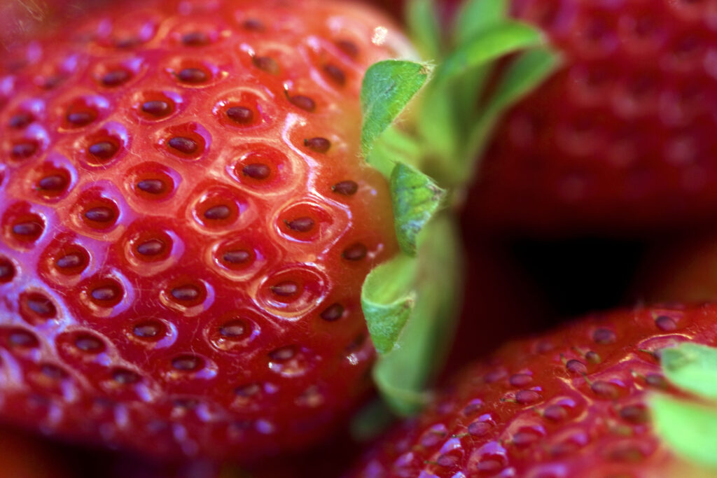 Macro Close-Up of Ripe Red Strawberries - Detailed Wallpaper Background