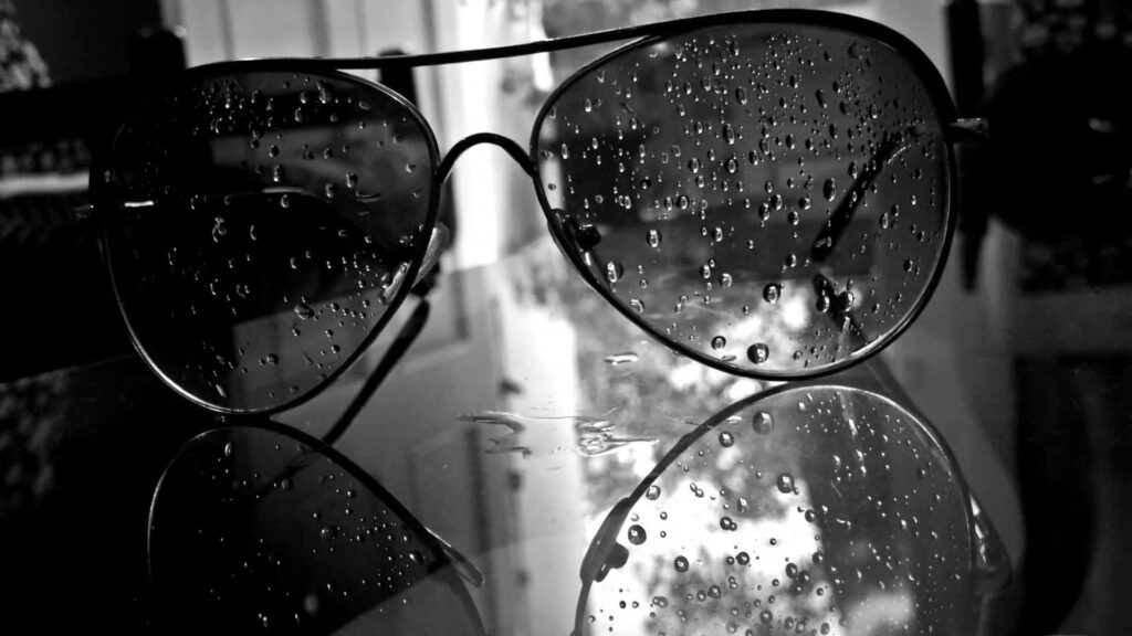 Artistic Monochrome Sunglasses Wallpaper on Reflective Surface