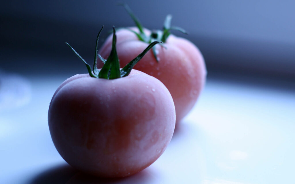 Close-Up of Frosty Pink Tomatoes: Soft Lighting Wallpaper Background