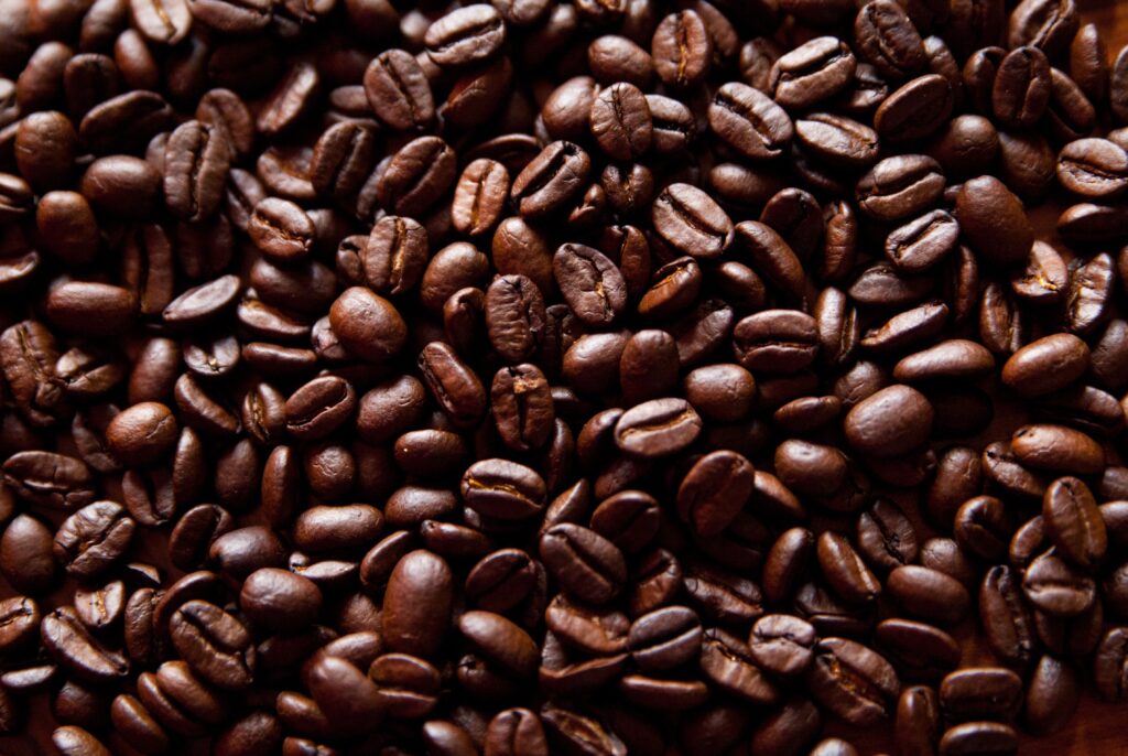 Close-Up of Glossy Roasted Coffee Beans - Perfect Wallpaper for Coffee Lovers