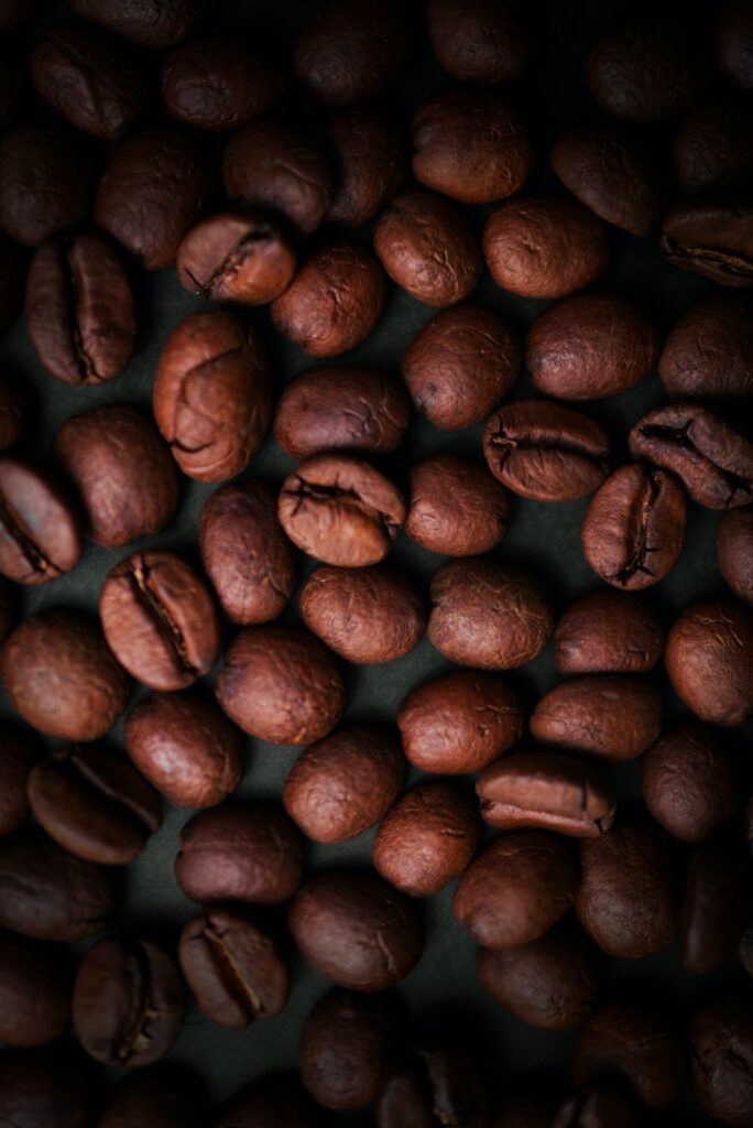 Warm Brown Wallpaper: Close-Up of Roasted Coffee Beans Background