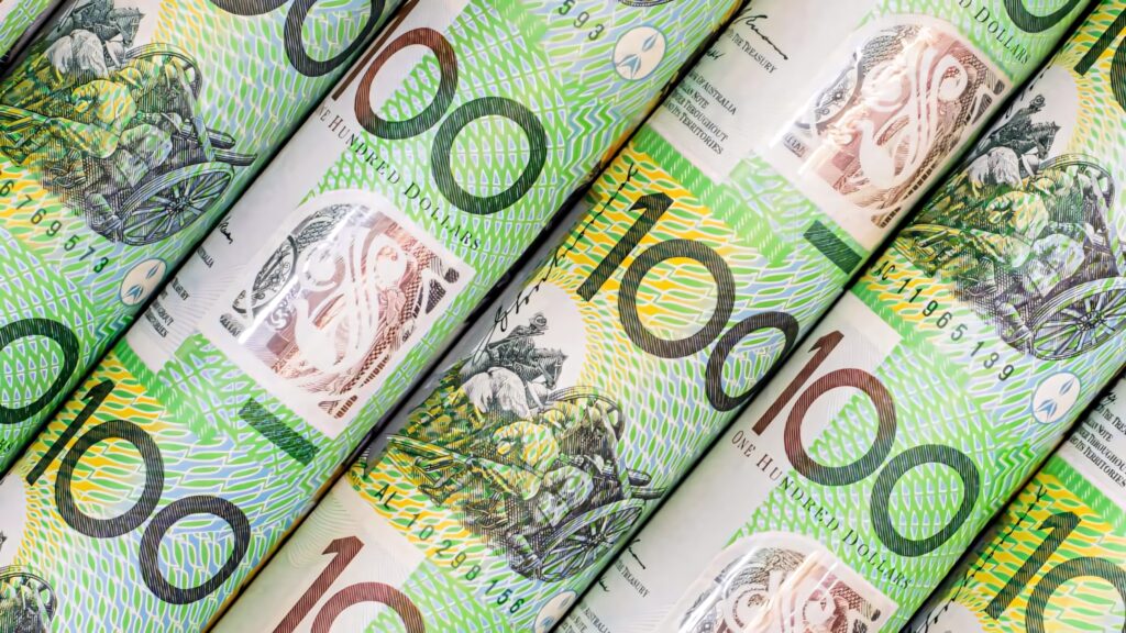 Close up rolled Australian 100 Dollar notes vibrant green with detailed security patterns wallpaper background