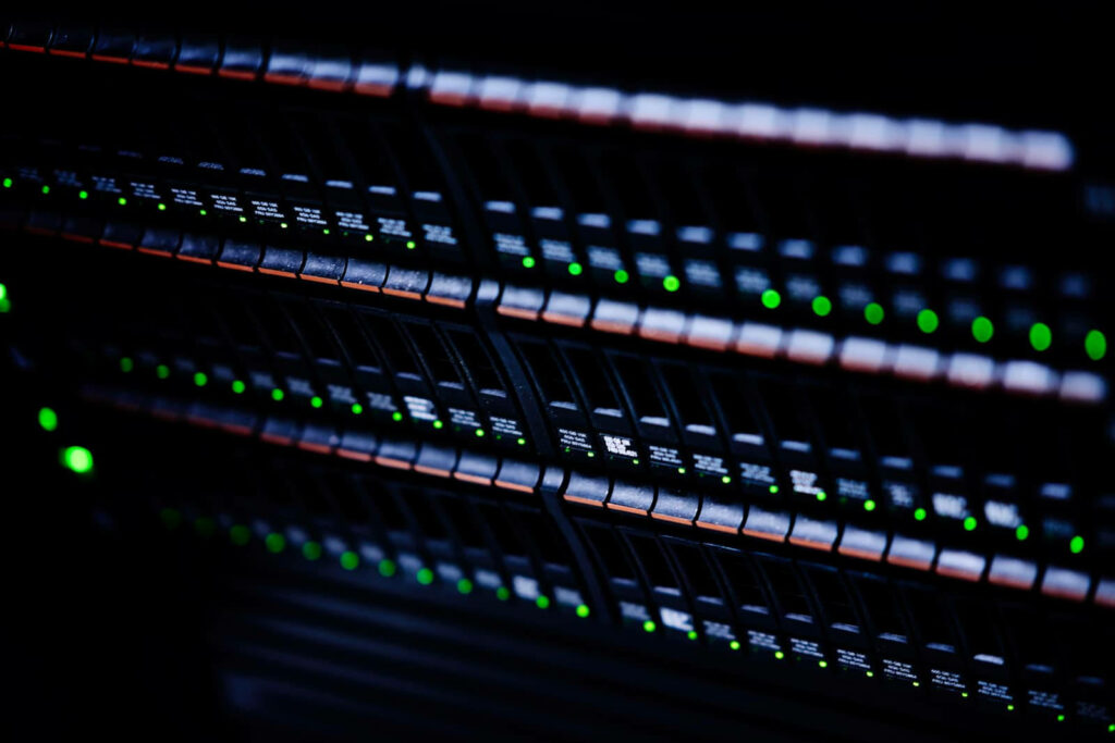 Close-up of Bluerange data center server racks with glowing green and orange indicator lights Wallpaper