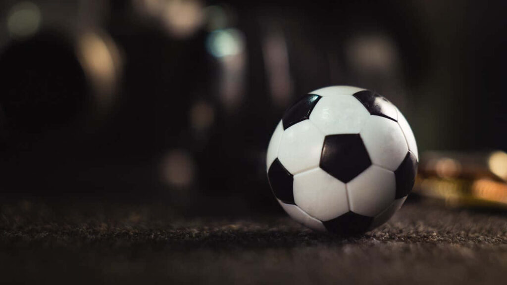 Soccer Ball Close-Up on Textured Surface - Sporty Wallpaper Background