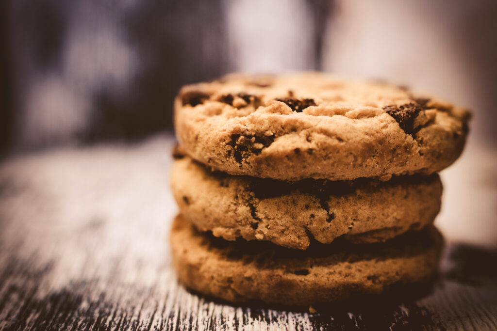 Close-Up Stack of Chocolate Chip Cookies - Warm Tones Wallpaper