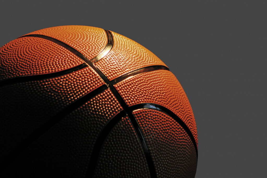 High-resolution basketball close-up wallpaper with vibrant orange texture on dark background