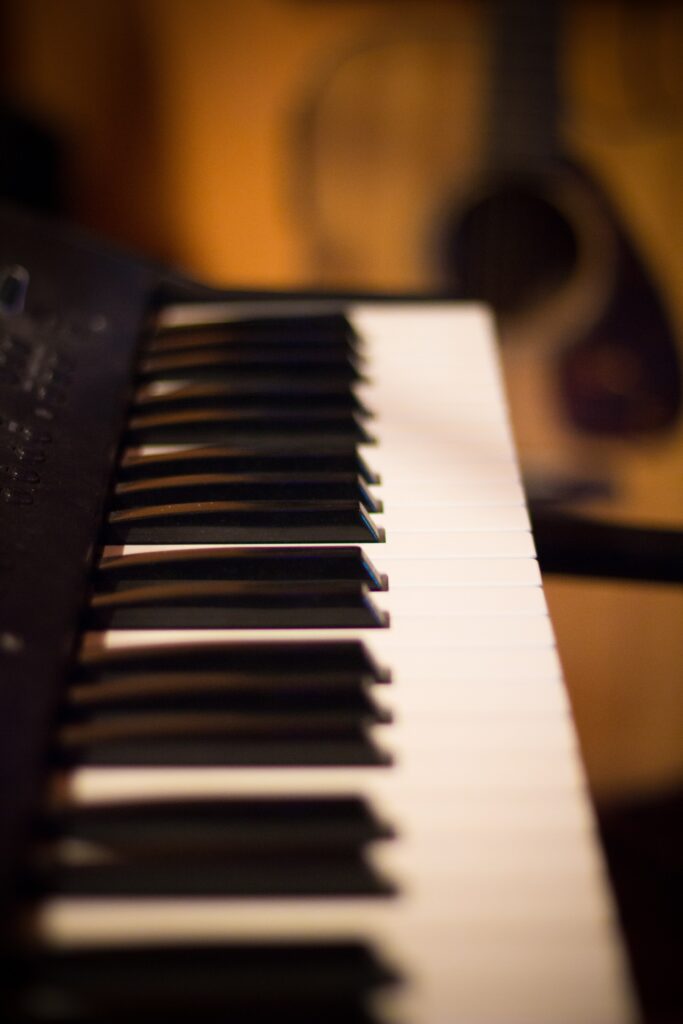 Sleek Synthesizer Keys & Guitar: Artistic Music Wallpaper Background