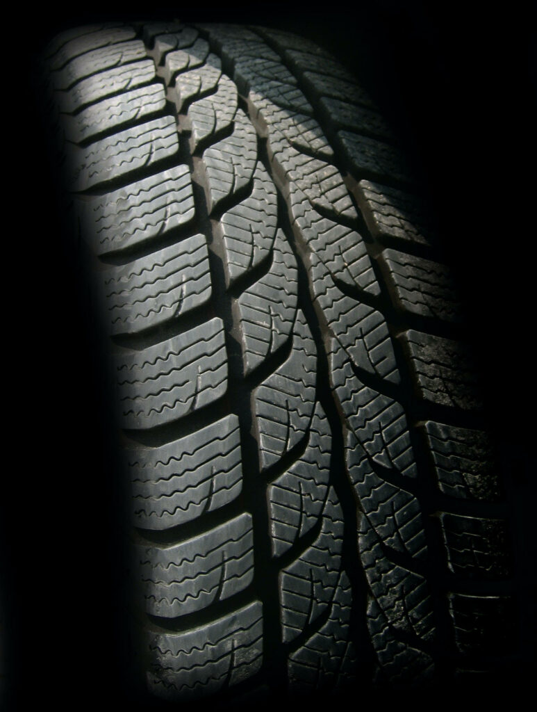 Intricate Tire Tread Close-Up: Sleek Modern Wallpaper Design