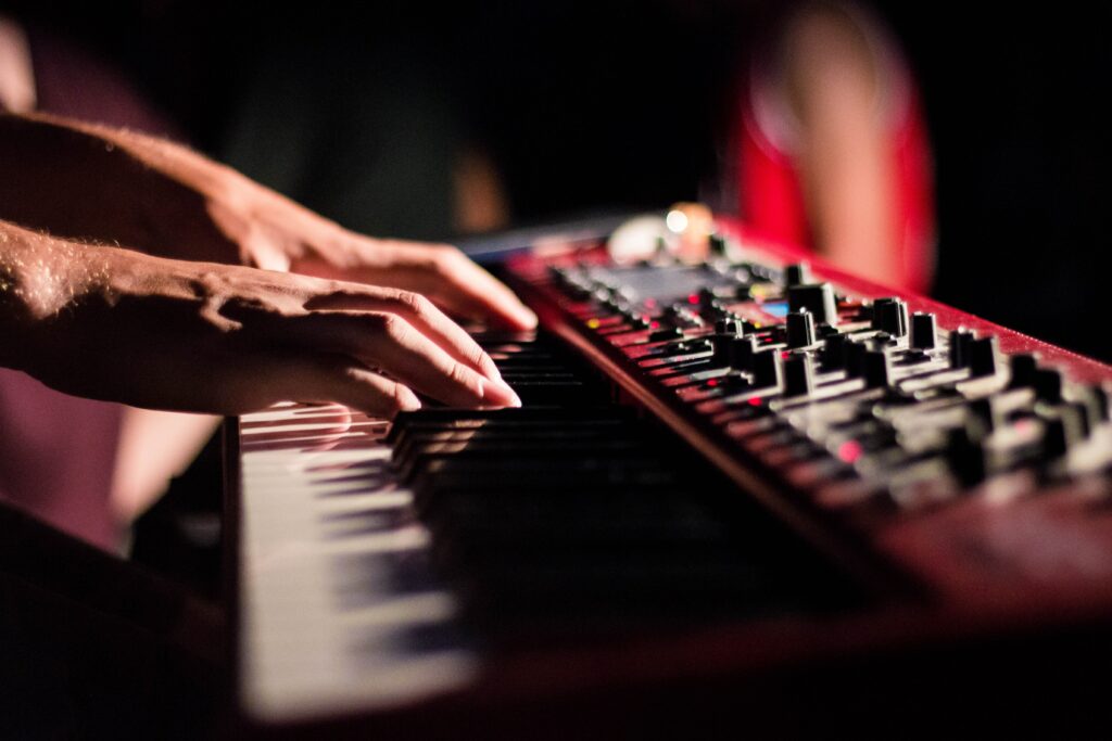 Close-Up Wallpaper: Hands on Synthesizer Showcasing Musical Creativity