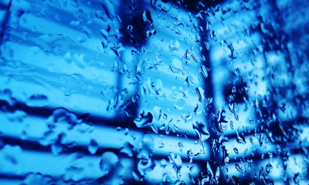 Vibrant Blue Water Droplets on Glass - Textured Abstract Wallpaper