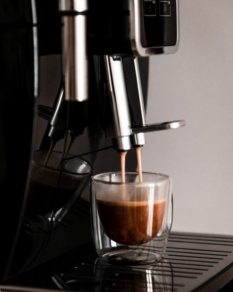 Close-Up of Coffee Machine Dispensing Rich Brew - Wallpaper Background