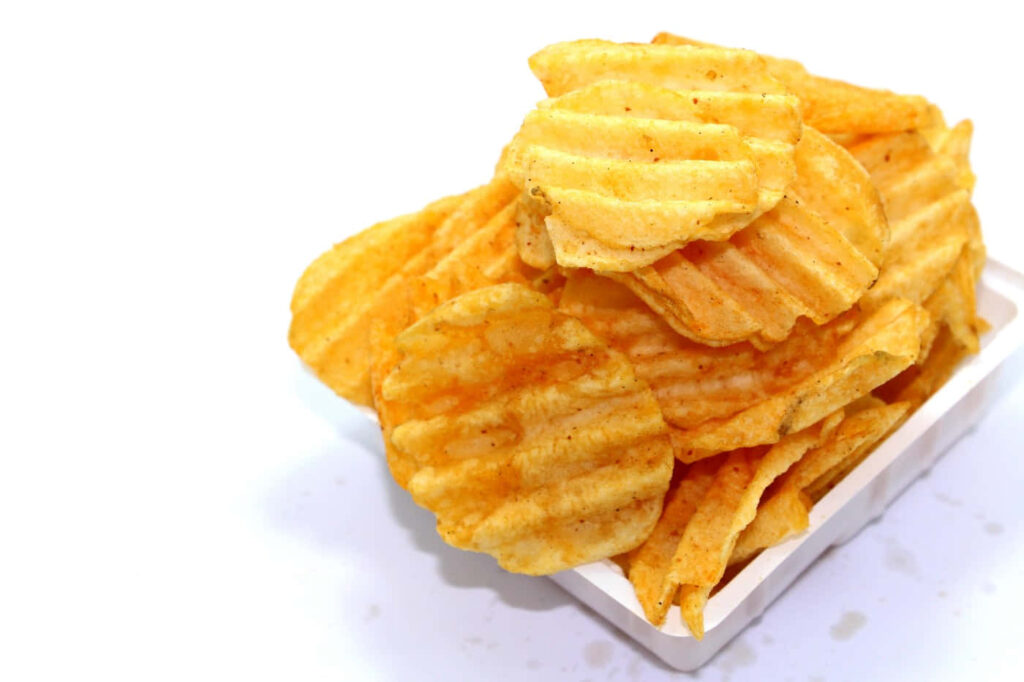 Golden Crispy Ridge Potato Chips in a Container: Tempting Wallpaper