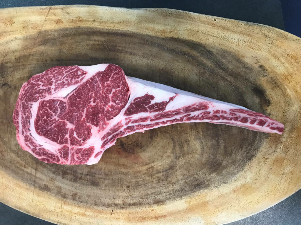 Stunning Kobe Beef Rib Steak Close-Up on Rustic Wood Wallpaper