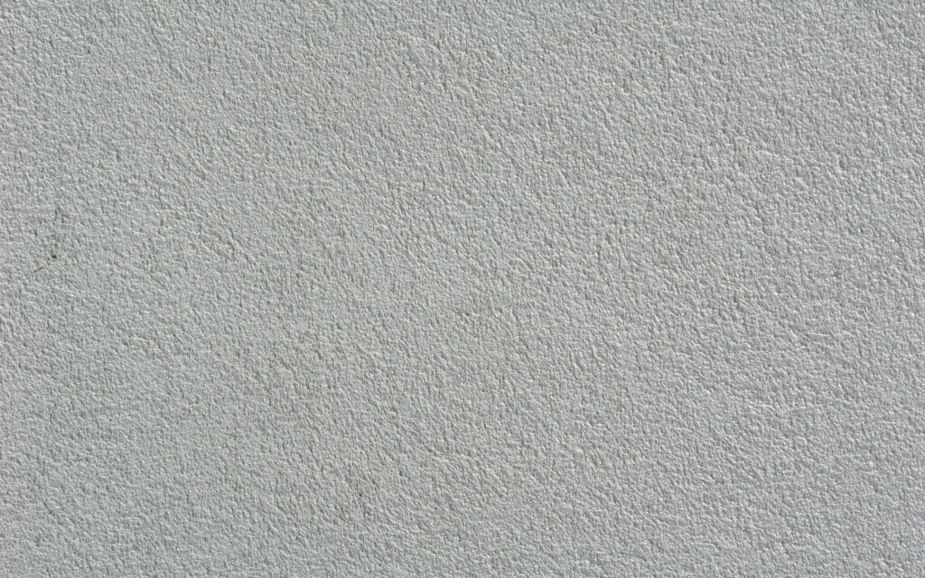 Textured White Wall Close-Up: Minimalist Rough Wallpaper Background