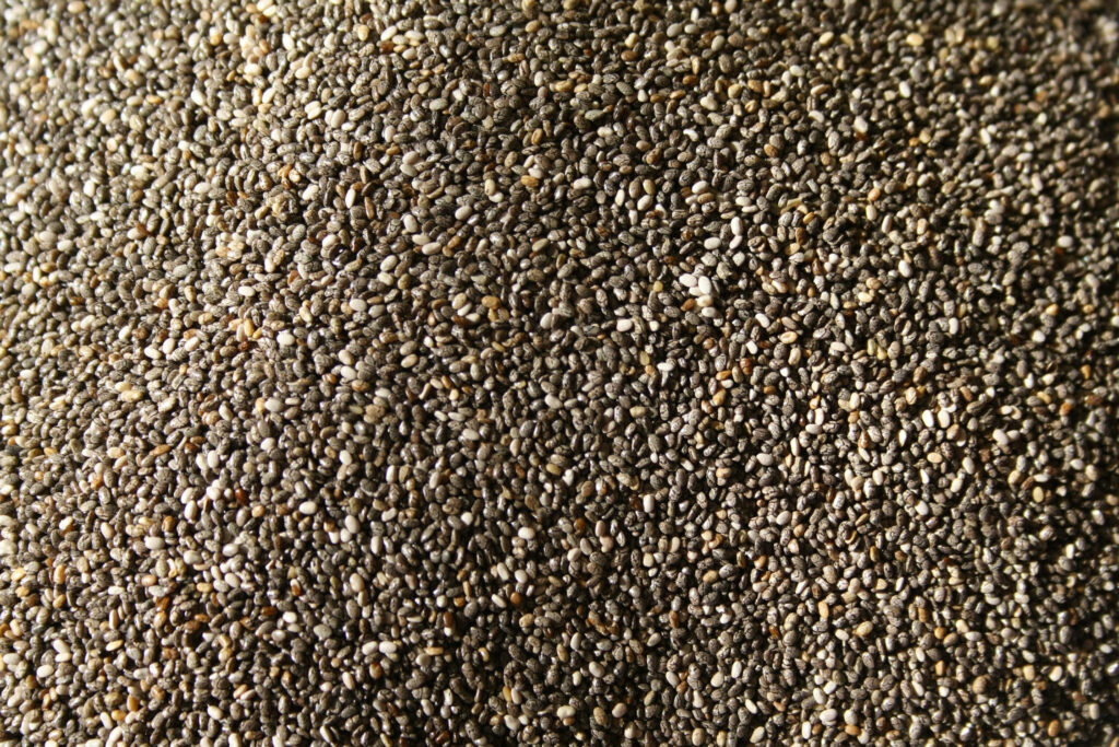 Close-up of chia seeds texture with earth tones resembling natural sand organic wallpaper background