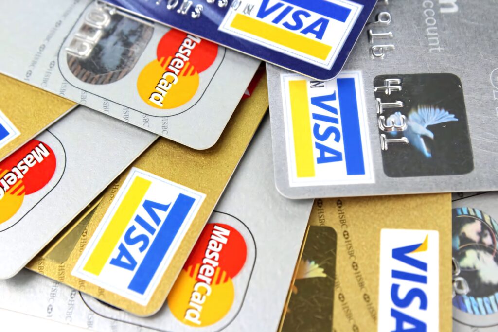 Close-up of layered credit cards with Visa and MasterCard logos in gold silver and blue tones Wallpaper