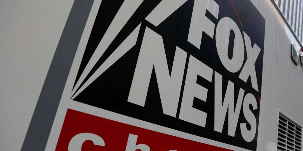 Close-up of Fox News logo on white media truck with sharp angle and high contrast colors Wallpaper
