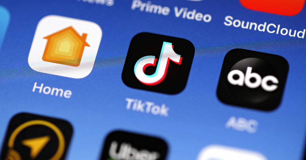 Close-up of smartphone screen showing TikTok app icon among popular apps for wallpaper use