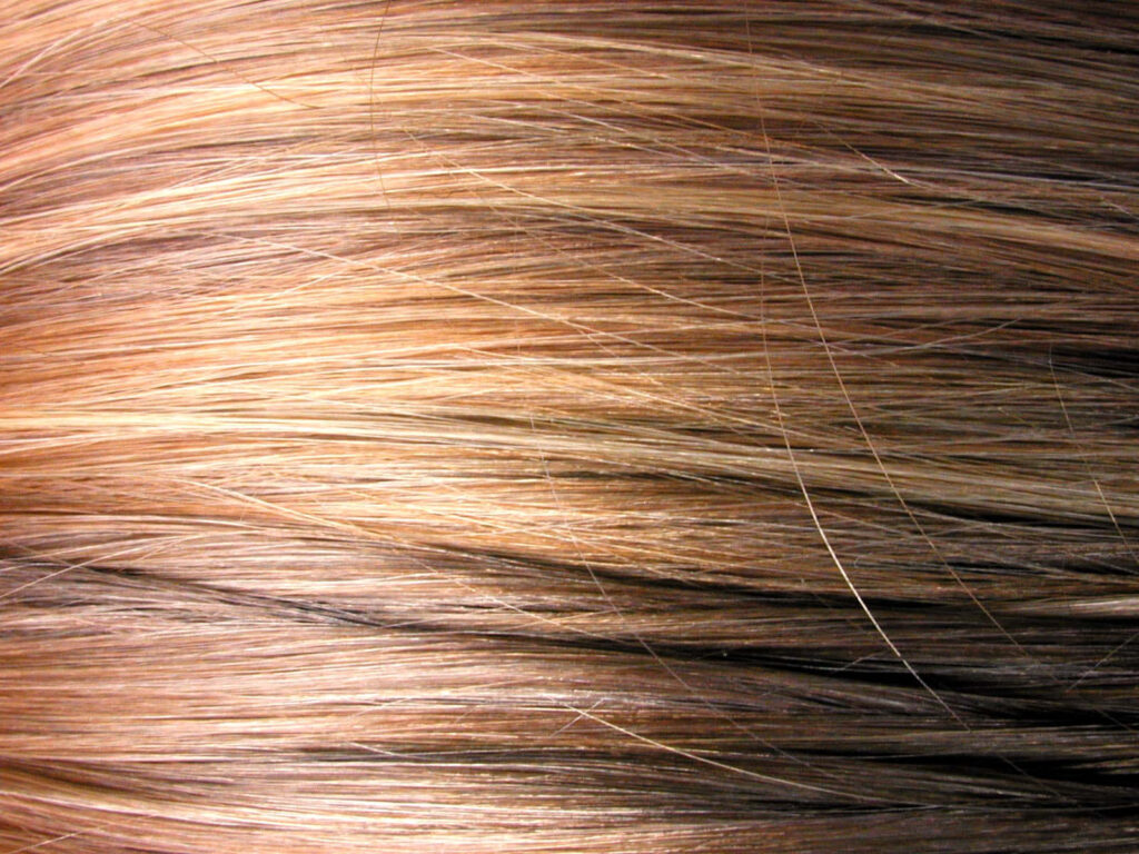 Textured Wallpaper: Glossy Brown Hair Strands with Natural Highlights