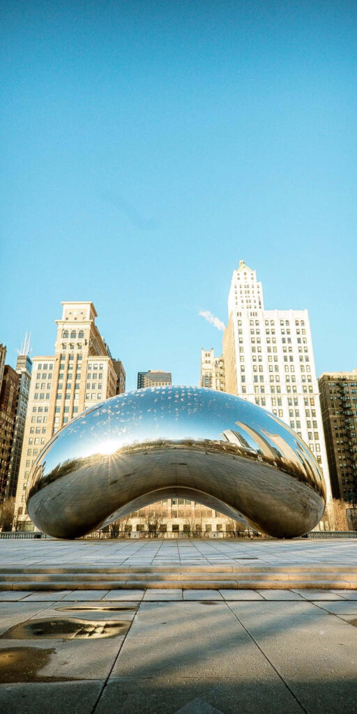 Cloud Gate sculpture The Bean reflective surface showing Chicago skyscrapers and blue sky wallpaper
