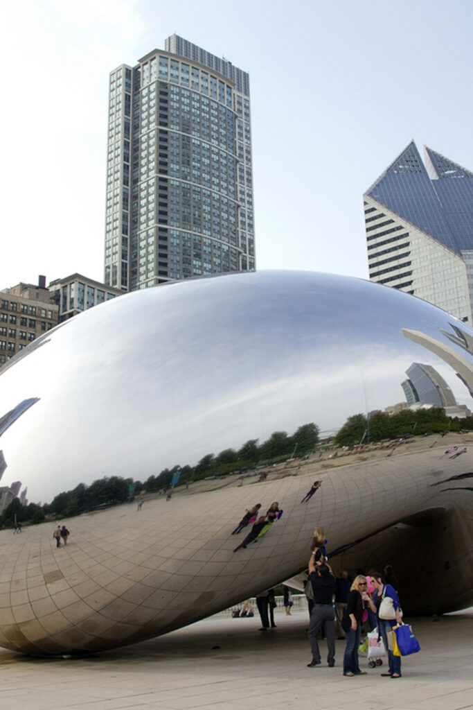 Cloud Gate Chicago sculpture reflecting visitors and skyscrapers under clear sky vertical wallpaper