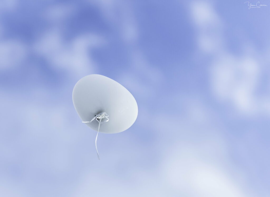 Ethereal Bliss: 4K Wallpaper of Majestic Balloon Soaring through the White Clouds in the Expansive Sky