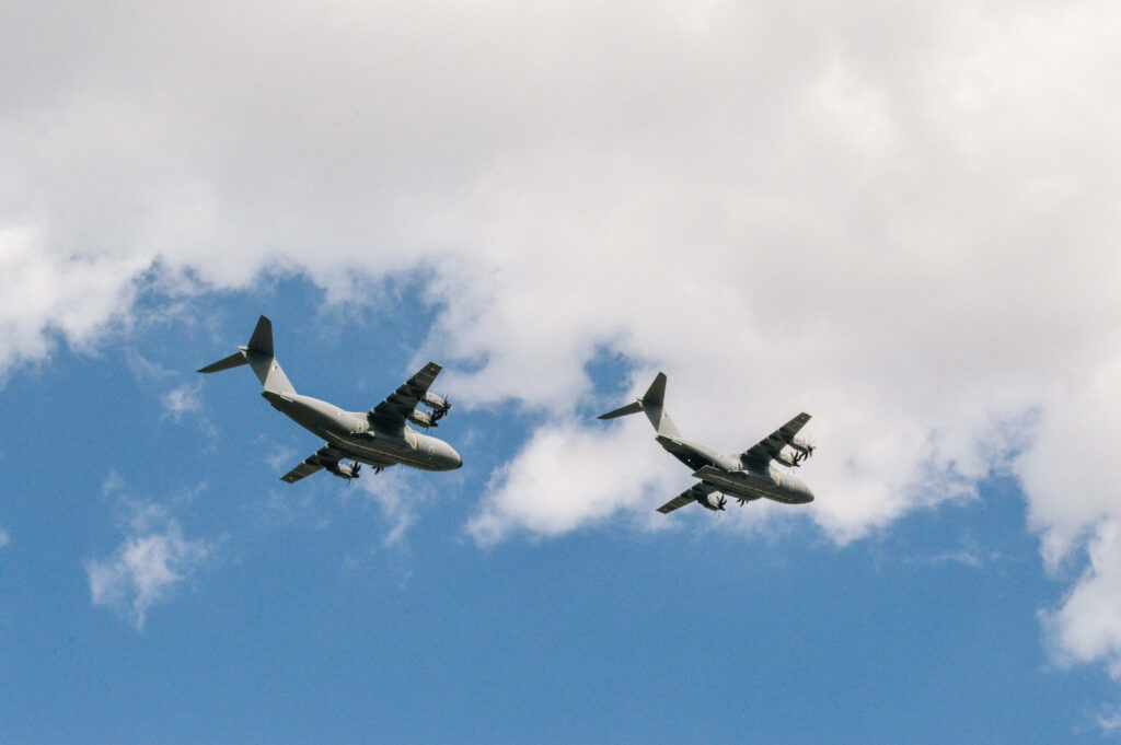 Airbus A400M Atlas: Majestic Military Aircraft Models Soaring Through Cloudy Skies in Microsoft Flight Simulator Wallpaper
