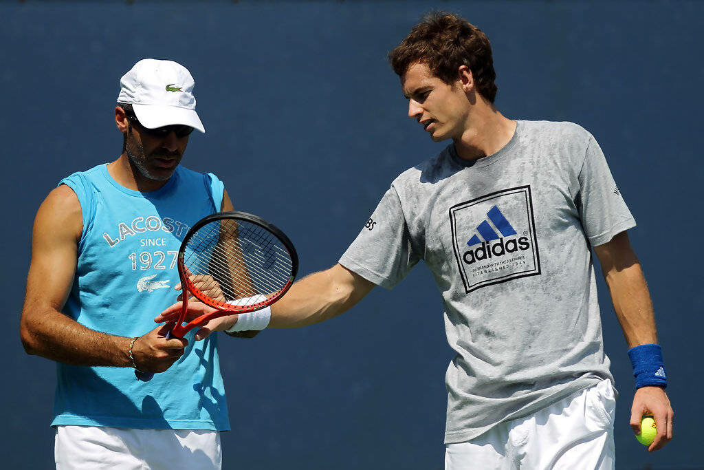 Coach Alex Corretja training Andy Murray in tennis techniques during focused practice session Wallpaper
