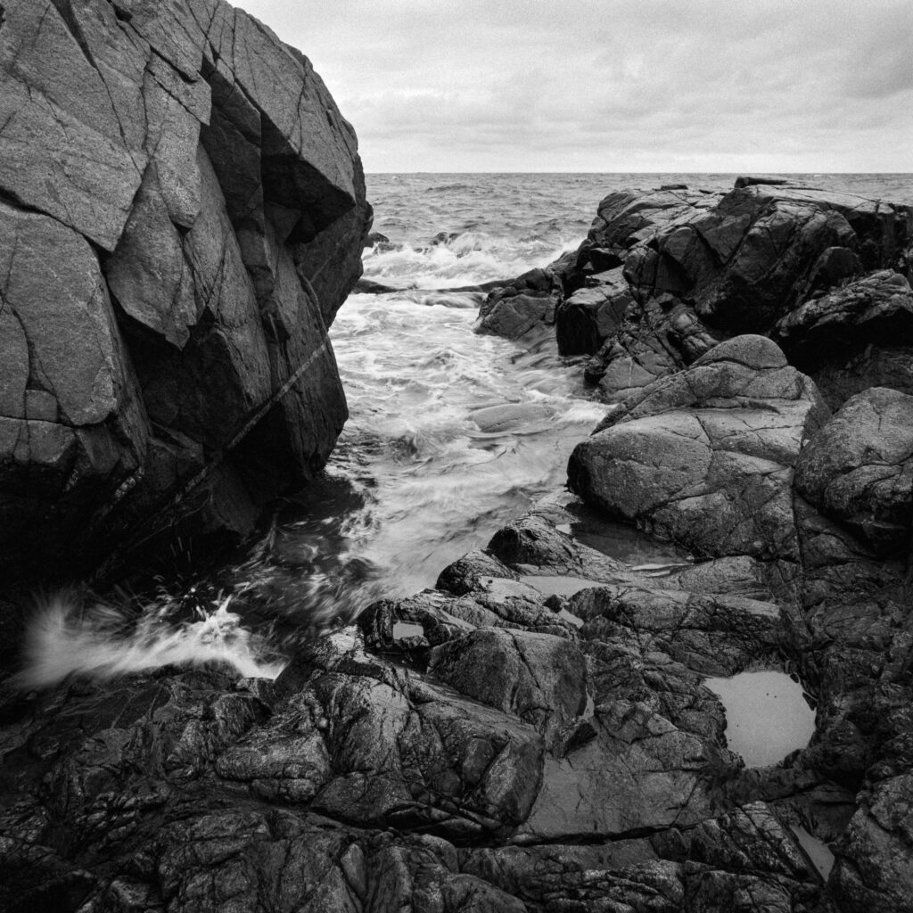 Dramatic B&W Coastal Wallpaper: Waves & Rugged Rocks Background