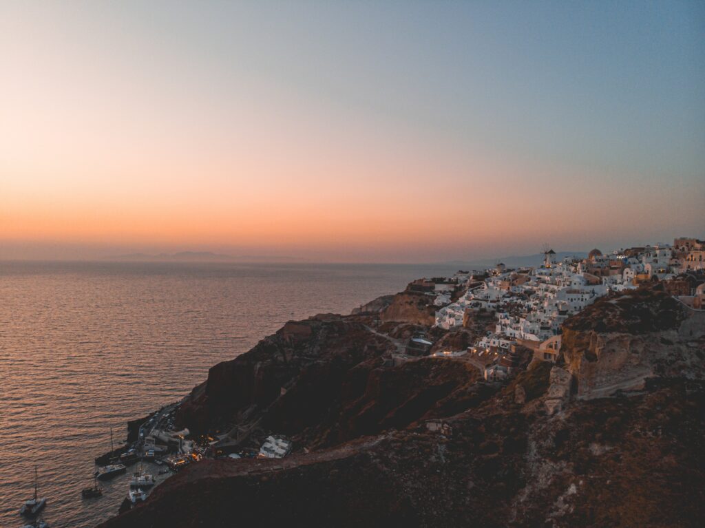 Coastal Town Aerial Wallpaper: Serene Sunset & Rugged Cliffs